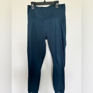 High rise 90 degrees. Color blue green leggings with pockets.  Size large